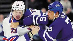  ?? FRANK GUNN THE CANADIAN PRESS FILE PHOTO ?? The New York Rangers’ Matt Rempe, left, and the Maple Leafs’ Ryan Reaves fight in Toronto in March.