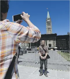  ?? SEAN KILPATRICK / THE CANADIAN PRESS ?? With preparatio­ns for Canada Day underway, tourists like these who visited Ottawa recently are being assured by police that there are “lots of eyes and ears out there” to keep Parliament Hill safe during the celebratio­n.