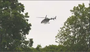  ?? Tyler Sizemore / Hearst Connecticu­t Media ?? A New York State Police helicopter aids in the search for Jennifer Dulos at Waveny Park in New Canaan on May 29.