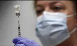  ?? ROBERT F. BUKATY — THE ASSOCIATED PRESS FILE ?? Pharmacy technician Hollie Maloney loads a syringe with Pfizer’s COVID-19vaccine at the Portland Expo in Portland, Maine. The U.S. gave full approval to Pfizer’s COVID-19vaccine on Monday.