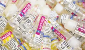  ?? Jessica Christian / The Chronicle ?? Bottles of liquid nicotine refills sit in bins as they are prepared for shipping from the Apollo Ecigs warehouse in Livermore.