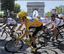  ??  ?? Street fighter: Wiggins passes the Arc de Triomphe yesterday
AP