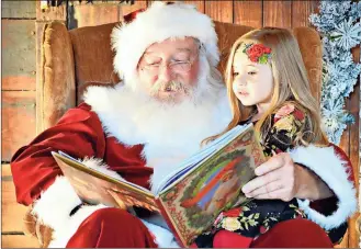  ?? Contribute­d photo ?? Cianna Stewart, the daughter of Sky Stewart, reads a book with “Santa” Ronnie Worthingto­n of Cedartown. This is Worthingto­n’s 19th year appearing as Santa.