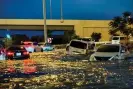  ?? Photograph: Giuseppe Cacace/AFP/ Getty Images ?? Cars sit abandoned in a flooded street after heavy rain in Dubai on Wednesday.