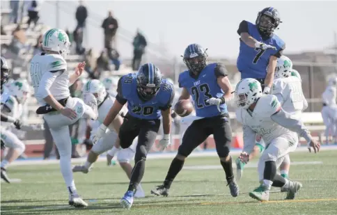  ?? ALLEN CUNNINGHAM/SUN-TIMES ?? Lincoln-Way East’s Matt Kordas (7) blocks a punt last fall against Notre Dame. Football is likely on hold in Illinois until at least spring.