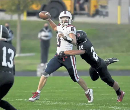  ??  ?? Chaparral quarterbac­k Josh Covak ( 8) throws under pressure from Deion Maes ( 20) in the first half Thursday night.