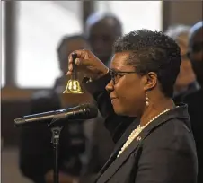  ??  ?? Consul General of Canada Nadia Theodore rings a bell for peace during Monday’s service. Officials from consulates including Jamaica, Mexico, Japan and Ireland rang bells for peace.