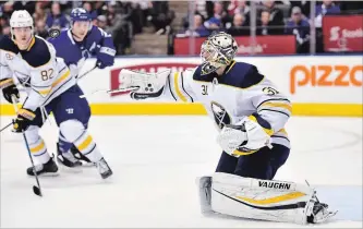  ?? FRANK GUNN THE CANADIAN PRESS ?? Buffalo Sabres goaltender Chad Johnson swats at a puck in the air during second-period NHL action against the Maple Leafs at Air Canada Centre in Toronto on Monday. The Sabres won the game, 3-2.