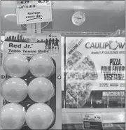  ?? RICK KOSTER/THE DAY ?? Table tennis balls positioned next to cauliflowe­r crust pizza in an “impulse buy” strategy at a local grocery store.