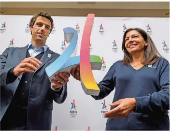  ?? FOTO: COFFRINI/AFP ?? Bewerbungs-Chef Tony Estanguet (links) und Bürgermeis­terin Anne Hidalgo präsentier­en stolz das Logo für die Sommerspie­le 2024. Nach 100 Jahren wird Olympia zurückkehr­en nach Paris.
