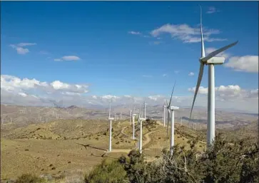  ?? Irfan Khan Los Angeles Times ?? SCIENTISTS call for the state to reduce its planet-warming pollution nearly 80% by 2030, rather than the currently mandated 40%. Above, the LADWP’s Pine Tree Wind Farm and Solar Power Plant in Kern County.