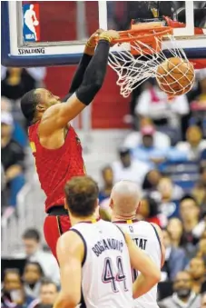  ?? THE ASSOCIATED PRESS ?? Atlanta Hawks center Dwight Howard dunks as Washington Wizards guard Bojan Bogdanovic and center Marcin Gortat, right, look on during Game 5 of their first-round playoff series Wednesday in Washington.
