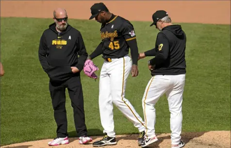  ?? Gene J. Puskar/Associated Press ?? Pirates pitcher Aroldis Chapman leaves the mound due to a cracked fingernail in the 10th inning of a game against the Chicago Cubs Sunday at PNC Park.