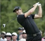  ?? SETH WENIG — THE ASSOCIATED PRESS ?? Dustin Johnson watches his tee shot on the 11th hole during the first round of the PGA Championsh­ip. Johnson, the reigning U.S. Open champion, shot a 77.