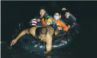  ?? (Go Nakamura/Reuters) ?? MIGRANTS CROSS the Rio Grande on an inflatable raft into the US from Mexico at Roma, Texas, on Friday.