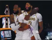  ?? MARK J. TERRILL — THE ASSOCIATED PRESS ?? The Lakers’ LeBron James, left, and Anthony Davis celebrate after L.A. defeated the Miami Heat 106-93 in Game 6 of the NBA Finals on Sunday to win the title.