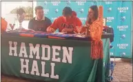  ?? Joe Morelli / Hearst Connecticu­t Media ?? Ben James of Milford, middle, signs a National Letter of Intent to play college golf at the University of Virginia at Hamden hall Country Day on Thursday. Sitting with James are his parents, Don and Gretchen.