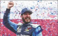  ?? Jared C. Tilton / Getty Images ?? Martin Truex Jr. celebrates in Victory Lane after winning the Monster Energy NASCAR Cup Series Bank of America 500 on Sunday in Charlotte, N.C.