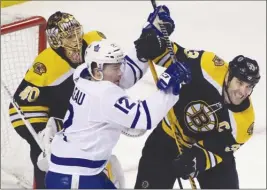  ?? The Associated Press ?? Toronto Maple Leafs forward Patrick Marleau, left, struggles for position against Boston Bruins defenceman Zdeno Chara in front of Bruins goaltender Tuukka Rask during Thursday’s series opener in Boston.