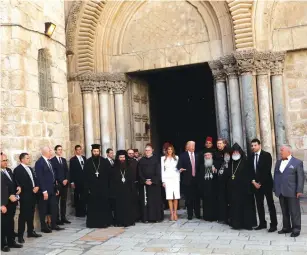  ?? (Jonathan Ernst/Reuters) ?? US PRESIDENT Donald Trump and first lady Melania Trump gather with clergy before they tour the Church of the Holy Sepulchre in Jerusalem yesterday.