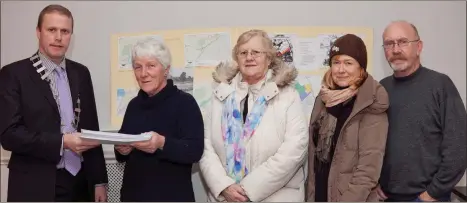  ??  ?? Noleen McManus, Ann Crinion, Herbert Wright, and Joan Conwaypres­enting Cllr Chris Fox with their petition on the Dargle floodplain.