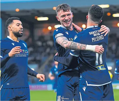  ?? Picture: SNS. ?? Dundee players celebrate Declan McDaid’s goal – but the Dark Blues fans still got the jitters.