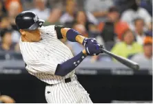  ?? Kathy Willens / Associated Press ?? The Yankees’ Aaron Judge hit a rookie-record 52 homers as New York grabbed an AL wild-card spot.