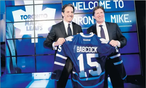  ?? — THE CANADIAN PRESS ?? Toronto Maple Leafs president Brendan Shanahan, left, and head coach Mike Babcock pose for photograph­ers following a news conference in Toronto on Thursday. Babcock, who coached the Red Wings for 10 seasons, has an eight-year deal with the Leafs.