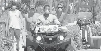  ?? JOE CAVARETTA/SOUTH FLORIDA SUN SENTINEL ?? Lifeguards wear masks while patrolling the beach Sept. 30 in Lake Worth amid red tide concerns.