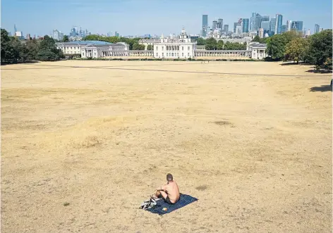  ?? ?? HEATWAVE: A parched Greenwich Park, London, yesterday after an official drought was declared for parts of England – but thundersto­rms and heavy rain, which have already hit parts of Scotland, could be on the way.