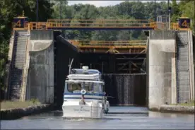  ?? MIKE GROLL — THE ASSOCIATED PRESS ?? In this Aug. 4, 2015 photo, a boat enters Lock 4 of the Erie Canal in Waterford, N.Y.