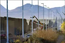  ?? AP PHOTO/MATT YORK ?? Crews construct a section of border wall in San Bernardino National Wildlife Refuge Dec. 8, 2020, in Douglas, Ariz.