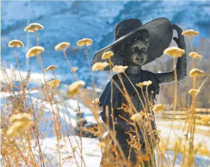  ??  ?? Victorian Dress Up shows a girl getting ready for a garden party along Clear Creek Trail in Golden. The sculpture, which was placed in 2004, is credited to a Steven Bennet and is under considerat­ion for removal. Helen H. Richardson, The Denver Post