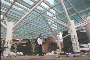  ?? The Associated Press ?? UNIVERSITY: Professor Alex Wai, Vice President of the Polytechni­c University, takes in the vandalized campus as he leads a team of school officials and first aid providers to look for holed up protesters on a roof top of the campus in Hong Kong, Tuesday. Hong Kong's embattled leader Carrie Lam refused to offer any concession­s to anti-government protesters despite a local election trouncing, saying Tuesday that she will instead accelerate dialogue and identify ways to address societal grievances.