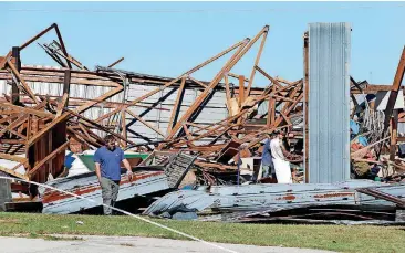  ?? [PHOTOS BY STEVE SISNEY, THE OKLAHOMAN] ?? Damage to buildings near Norman is being assessed Sunday. Several businesses were damaged by an apparent tornado that struck near Interstate 35 and State Highway 9 on Saturday night.
