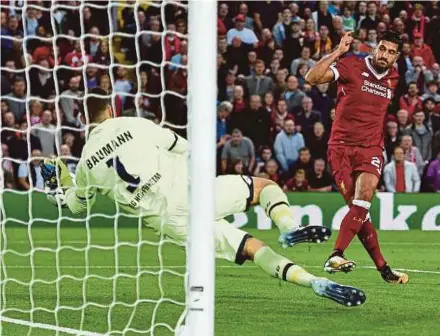  ?? AFP PIC ?? Liverpool’s Emre Can scores past Hoffenheim goalkeeper Oliver Baumann in their Champions League playoff second leg at Anfield on Wednesday.