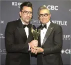  ?? The Canadian Press ?? Daniel Levy and Eugene Levy pose for a photo after winning the award for “Best Comedy Series” at the Canadian Screen Awards in Toronto in 2019.