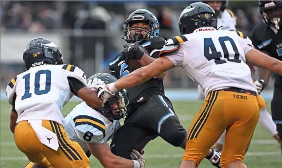  ?? Lucy Schaly/Post-Gazette ?? Woodland Hills’ Brandon Jones gets surrounded by the Central Catholic defense on Friday.