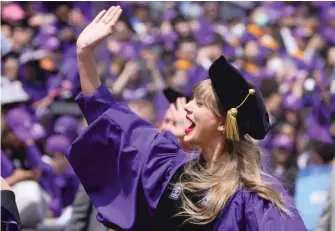  ?? AP ?? Taylor Swift waves Wednesday during New York University’s graduation ceremony at Yankee Stadium.