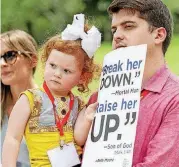  ?? [AP PHOTO] ?? Chase Crawford, a Southern Baptist Convention messenger from Arkansas, and his 2-year-old daughter, Chloe Jean Crawford, listen Tuesday to speakers in Dallas.