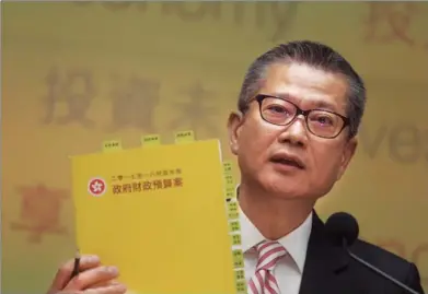  ?? ROY LIU / CHINA DAILY ?? Financial Secretary Paul Chan Mo-po unveils the 2017-18 Budget with a record HK$92 billion surplus and a HK$32 billion basket of sweeteners — his first as the city’s financial chief — to the press at the Central Government Complex in Admiralty on...