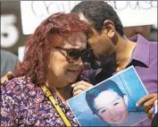  ?? Liz Moughon Los Angeles Times ?? EVA HERNANDEZ, Noah Cuatro’s great- grandmothe­r who at times was his caretaker, is comforted by activist Najee Ali at a news conference in July.