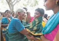  ?? Associated Press ?? A boy cries as he is consoled by his grandmothe­r after his mother died of food poisoning at Bidarahall­i in Chamarajna­gar on Saturday.