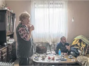  ??  ?? LEFT Ljiljana Trifonovic and her son, Milan, at their home near the artificial lake.