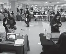  ?? Kin Man Hui/staff photograph­er ?? Job applicants meet with school administra­tors at a job fair for San Antonio ISD teaching positions in July. It is unacceptab­le that teachers in our state are underpaid.