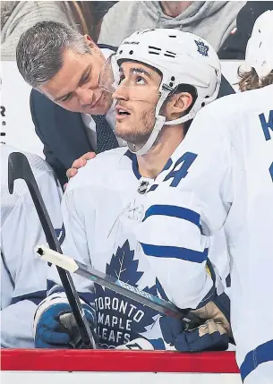  ?? CHRISTIAN PETERSEN GETTY IMAGES FILE PHOTO ?? Sheldon Keefe, having a word with Pierre Engvall in his first game behind the Leafs’ bench, has players buying in after one of the NHL’s seven mid-season coaching changes.
