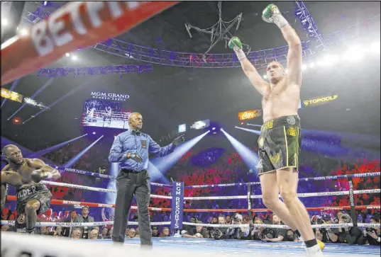  ?? Erik Verduzco Las Vegas Review-Journal @Erik_Verduzco ?? Tyson Fury, right, knocks down Deontay Wilder in the third round of their WBC heavyweigh­t bout at the MGM Grand Garden.