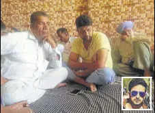  ?? HT PHOTO ?? Family of Vikram Jaryal (inset) at his native village Jandwal in Hoshiarpur on Saturday.