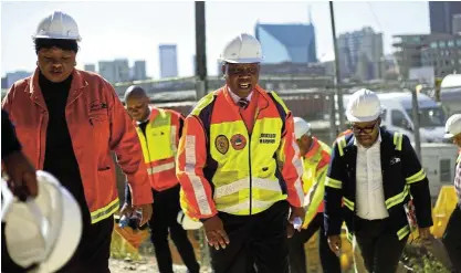  ?? Picture: Alaister Russell ?? Herman Mashaba, then executive mayor of Johannesbu­rg, is joined by Nonhlanhla Makhuba, left, as they inspect the progress done with the M1 in Johannesbu­rg when it was closed for traffic to carry out repairs.