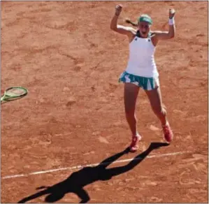  ?? CHRISTOPHE ENA — THE ASSOCIATED PRESS ?? Jelena Ostapenko celebrates after beating Simona Halep in 6-4, 6-3 in Paris on Saturday. three sets 4-6,